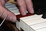Enlarge this image Measuring and adjusting piano key dip to restore a piano
