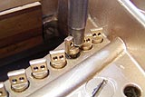 Removal of old piano agraffes during Steinway piano restoration