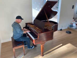 Client playing a restored 1925 Knabe parlor grand piano