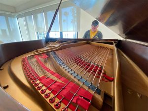 Client playing a restored 1925 Knabe parlor grand piano