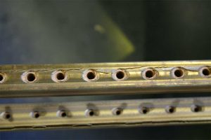 Defective and damaged Steinway and Sons piano patented Tubular Metallic Action Frame Rail requiring replacement