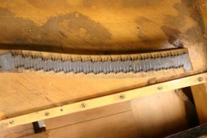 Old bridge on Steinway piano before restoration