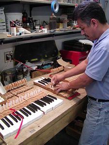 Piano key rebushing a crucial step in restoring pianos
