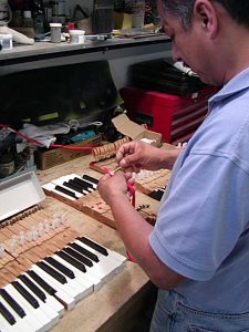 Piano key rebushing a crucial step in restoring pianos