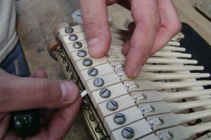 Traveling the piano hammershank during a piano restoration